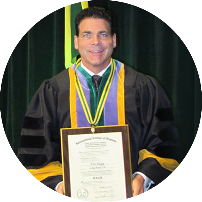 Dr. Silegy, holding diploma being certified by the American Board of Oral and Maxillofacial Surgeons.