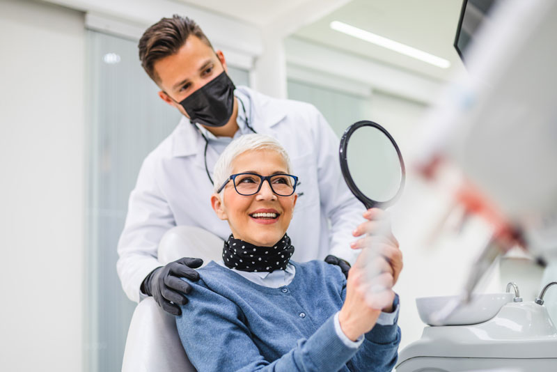 a dental patient smiling after dental implant surgery